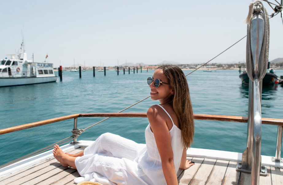 Woman relaxing on cruise deck ienjoying ocean breeze and sunshine