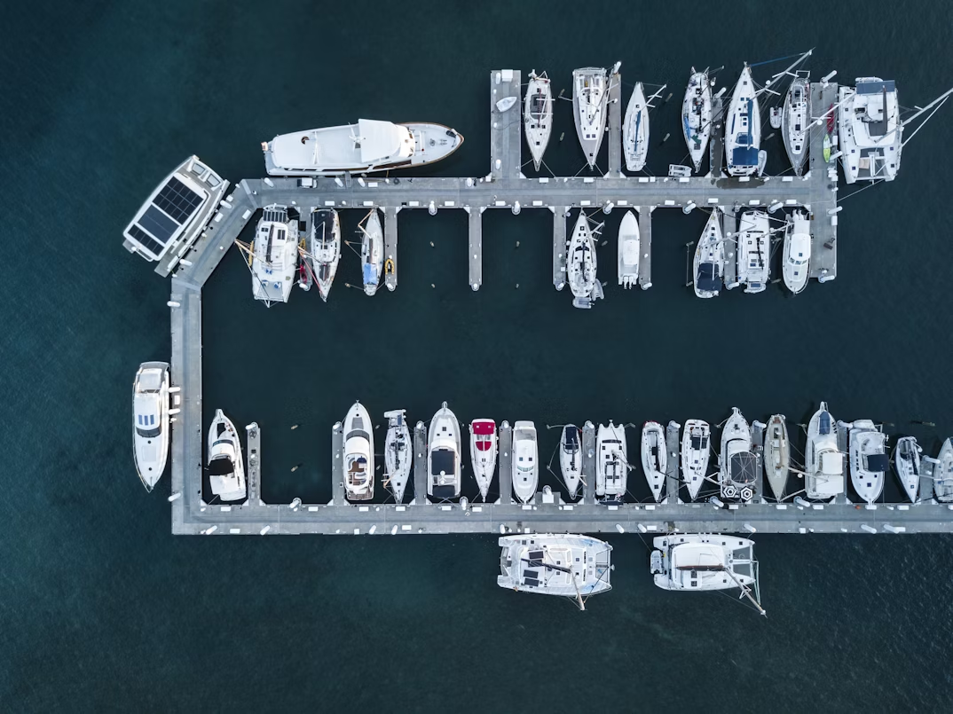 Aerial view of luxury yachts and sailboats docked at a marina before Yacht Week departure