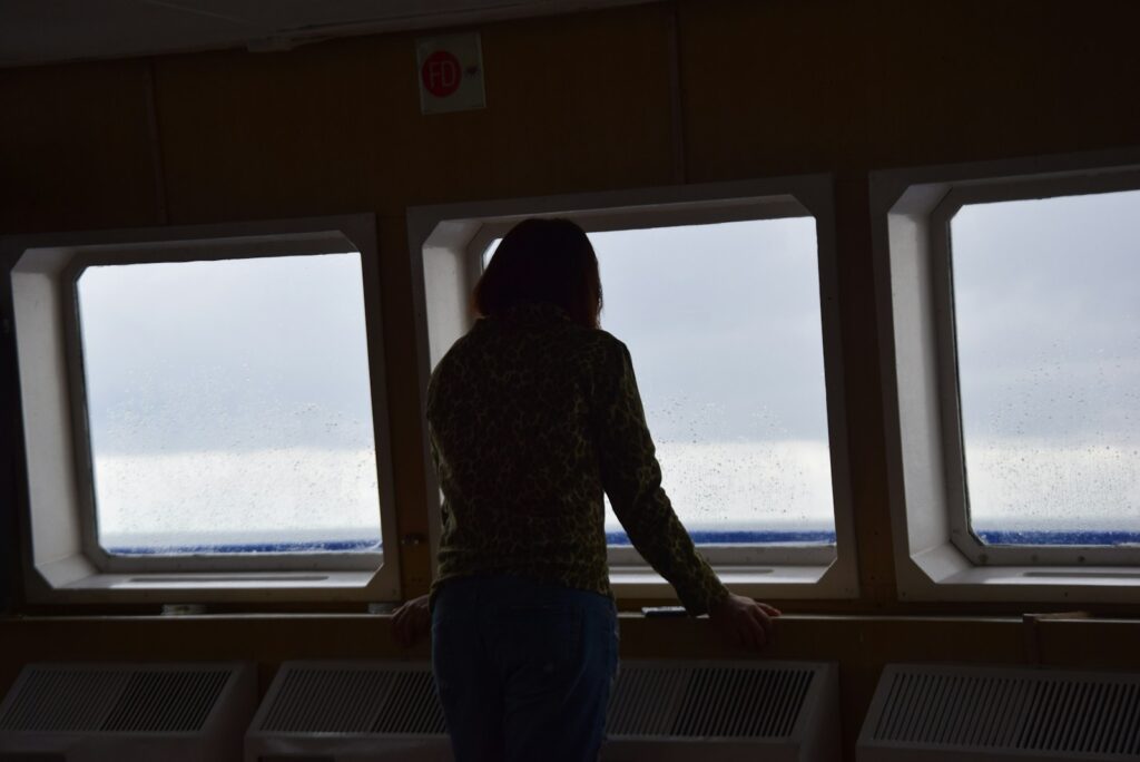 silhouette photo of woman leaning forward
